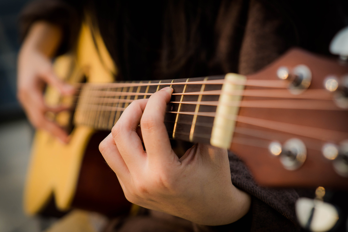 Person Playing Guitar